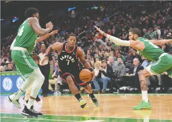  ?? BOB DECHIARA/USA TODAY SPORTS ?? Toronto Raptors guard Kyle Lowry dribbles past Boston Celtics’ Robert Williams, left, and Jayson Tatum on Friday at TD Garden. Despite Lowry’s 29 points, the Raptors lost 112-106.