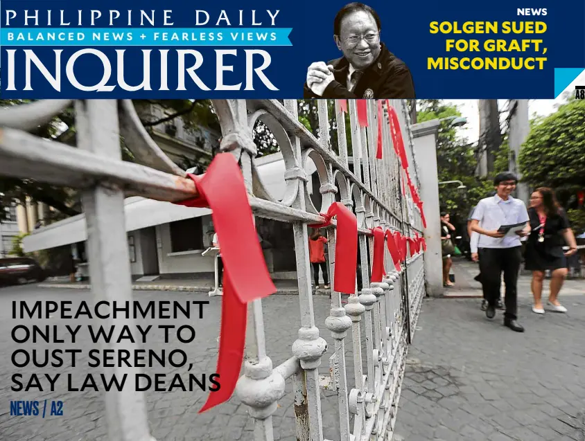  ?? —GRIG C. MONTEGRAND­E ?? SEEING RED People on Thursday walk by the gate of the Supreme Court compound in Manila festooned with red ribbons by the high tribunal’s employees to show they want the justices to back a petition to remove Chief Justice Maria Lourdes Sereno from office.