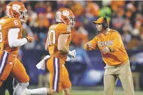  ?? GERRY BROOME/ASSOCIATED PRESS ?? Clemson head coach Dabo Swinney directs his players during the first half of the Atlantic Coast Conference championsh­ip against Virginia on Dec. 7 in Charlotte, N.C.