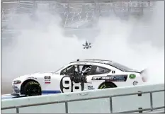  ?? WILFREDO LEE — THE ASSOCIATED PRESS ?? Chase Briscoe does a burnout after winning a NASCAR Xfinity Series auto race Sunday, in Homestead, Fla.