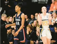  ?? AARON GASH/AP ?? Marquette’s Jordan King, right, claps in front of Uconn’s Aubrey Griffin during the second half Wednesday in Milwaukee.