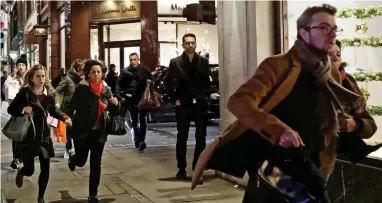  ??  ?? Chaos: Shoppers fearing a terrorist attack running away down Oxford Street last night
