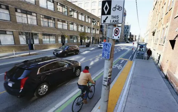  ?? ANDREW FRANCIS WALLACE/TORONTO STAR FILE PHOTO ?? If cyclists had widespread dedicated lanes, motorists wouldn’t have to hold their breath every time they have to pass a person on a bicycle.