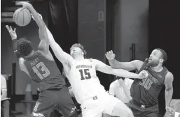  ?? NAM Y. HUH/AP ?? Northweste­rn center Ryan Young battles for a rebound against Maryland guard Hakim Hart, left, and forward Galin Smith during a game Wednesday night in Evanston, Ill.