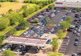  ?? WOODY MARSHALL/ NEWS & RECORD ?? Lines of vehicles snake through a parking lot Tuesday at a Costco in Greensboro, N.C., as drivers seek gas. The Colonial Pipeline, which delivers about 45% of the fuel consumed on the East Coast and South, was hit by a cyberattac­k Friday. The pipeline was closed for a fifth day Tuesday.