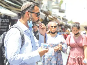  ?? (Marc Israel Sellem/The Jerusalem Post) ?? A BEN & JERRY’s fan gets his fix yesterday on a Jerusalem street.