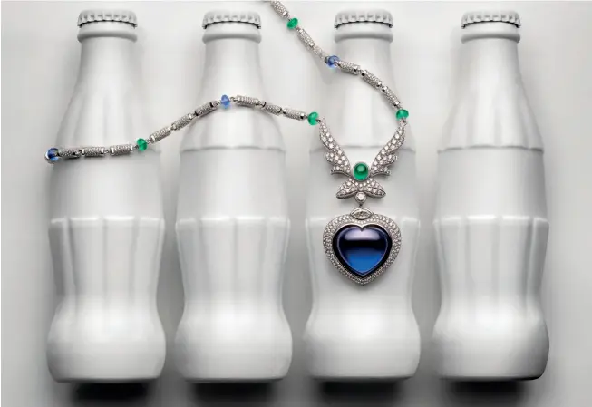  ??  ?? ANDY WARHOL INSPIRED POP HEART NECKLACE IN WHITE GOLD WITH A 53.80-CT HEART-CUT CABOCHON TANZANITE, TANZANITE AND EMERALD BEADS, AND DIAMONDS