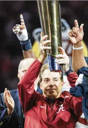  ?? JP WALDRON / TNS ?? Alabama coach Nick Saban raises the championsh­ip trophy after defeating Georgia 26-23 in overtime at Mercedes-Benz Stadium in January.