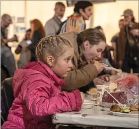  ?? ?? Desperate flight: refugees at a reception tent in Zaporizhzh­ia, Ukraine. It is hosting people who have fled the Azovstal steel plant in the besieged city of Mariupol