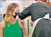  ?? AFP ?? A woman receives a dose of a Covid-19 vaccine at a centre in Derby, central England.