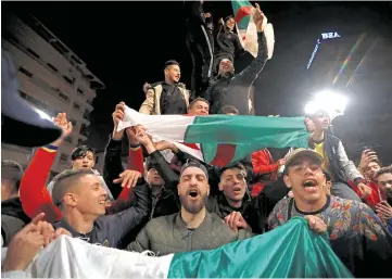  ??  ?? People celebrate on the streets after Bouteflika announced he will not run for a fifth term. — Reuters photo