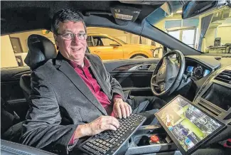  ?? POSTMEDIA NEWS ?? Grant Courville, vice-president, products and strategy at BlackBerry QNX, is pictured in a completely autonomous test vehicle. Blackberry recently struck a deal with Amazon to leverage its Intelligen­ce Vehicle Data Platform, called IVY.