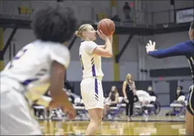  ?? Kathleen Helman / Ualbany athletics ?? Ualbany forward Ellen Hahne gets set to launch a shot against New Hampshire in the America East quarterfin­als on Sunday at SEFCU Arena. Hahne hit a key 3-pointer in the final minutes to help the fourth-seeded Danes advance to the semifinals next Sunday vs. top-seeded Maine in Orono.