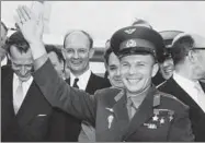  ?? AP ?? Gagarin waves after arriving in London on July 11, 1961.