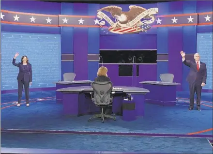  ?? ALEX WONG/GETTY ?? Democratic vice presidenti­al nominee Sen. Kamala Harris, left, and Vice President Mike Pence wave before the start of the debate in Salt Lake City.