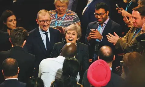  ?? AFP ?? ■ Britain’s Prime Minister Theresa May greets delegates after giving her keynote address on the fourth and final day of the Conservati­ve Party Conference in Birmingham, central England, yesterday.