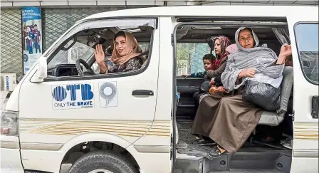  ?? — aFP ?? Social mobility: razia dalili (front seat) waving as she drives a women-only mini-bus in Kabul.