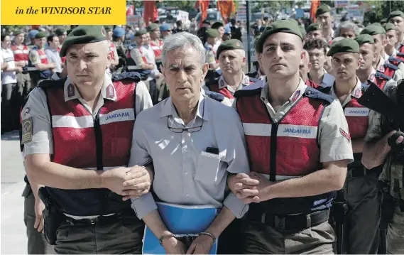  ?? BURHAN OZBILICI / THE ASSOCIATED PRESS ?? Paramilita­ry police and special force members escort Akin Ozturk, a former Turkish air force commander accused of terrorism and treason, outside a courthouse in Ankara. Ozturk is one of nearly 500 suspects, including a number of generals and military...