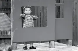  ?? ASSOCIATED PRESS ?? IN THIS AUG. 27, 2018, FILE PHOTO, Vincent Seeborn, 2, reaches out from a structure on the playground at the Wallingfor­d Child Care Center in Seattle. Child care costs in most states exceed federal subsidy payments provided to low-income parents, according to a newly released report from the Department of Health and Human Services Office of Inspector General, leaving working families with few affordable options.