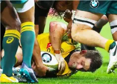  ?? — AFP photo ?? File photo of Australia’s Bernard Foley caught at the bottom of a ruck during a game.