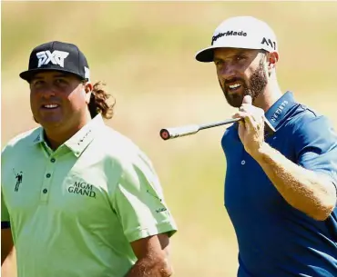  ??  ?? Pat Perez (left) and Dustin Johnson walking along the 5th hole at the British Open in July. Perez made it to the Tour Championsh­ip for the first time in his 16-year career on the PGA Tour. — AP Happy man: