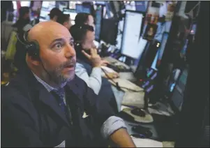  ?? The Associated Press ?? SHARPLY HIGHER: Trader Vincent Napolitano works on the floor of the New York Stock Exchange, Monday. Stocks are opening sharply higher on Wall Street, following gains in overseas markets after the U.S. and China struck a 90-day truce in their trade dispute.