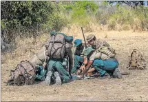  ?? Picture: AFP ?? COMBATING CRIME: British trooper and counter-poaching operator Samuel Knuckey, right, leads participan­ts in a GPS and map-reading training session during a counter-poaching training course for game rangers at the Liwonde National Park in Machinga...