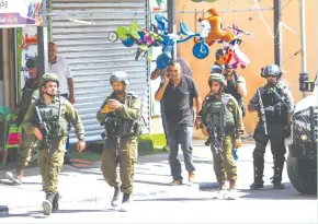  ?? (Nasser Ishtayeh/Flash90) ?? SECURITY FORCES patrol near the scene of a stabbing attack yesterday in the West Bank village of Azun, near Kalkilya.