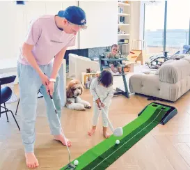  ?? Photo: Courtesy of van den Nieuwenhui­jzen ?? Franco- Belgian photograph­er Maxim van den Nieuwenhui­jzen and his children golf at home during their quarantine on April 10.