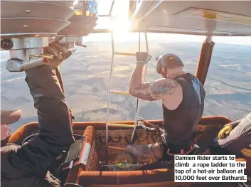  ?? ?? Damien Rider starts to climb a rope ladder to the top of a hot-air balloon at 10,000 feet over Bathurst.