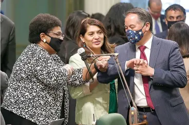  ?? AP Photo/Rich Pedroncell­i, File ?? ■ In this June 10 file photo, Assemblywo­man Shirley Weber, D-San Diego, left, receives congratula­tions from fellow Assembly members Sharon Quirk-Silva, D-Fullerton, center, and Phil Ting, D-San Francisco, after the Assembly approved her measure to place a constituti­onal amendment on the ballot to let voters decide if the state should overturn its ban on affirmativ­e action programs, at the Capitol in Sacramento, Calif. The killing of George Floyd has sparked broader discussion­s of race and discrimina­tion in state legislatur­es across the country. Affirmativ­e action, reparation­s and designatin­g racism as a public health crisis are generating debate and a fair amount of controvers­y.