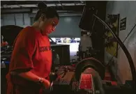  ??  ?? Ortiz, 35, gets ready to shave a brake rotor in the Harris County Jail’s auto mechanics program. Last month, Ortiz became one of the first women allowed in the program.