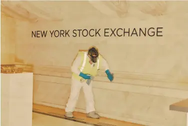  ?? Victor Llorente / New York Times ?? A worker cleans at the New York Stock Exchange in March. Big Tech stocks have proved impervious to the coronaviru­s pandemic since then. The markets continue to rally despite the lack of a second stimulus deal.