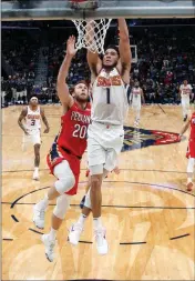  ?? ASSOCIATED PRESS ?? PHOENIX SUNS GUARD Devin Booker goes to the basket in front of New Orleans Pelicans forward Nicolo Melli (20) during the first half of Thursday’s game in New Orleans.
TIP-INS