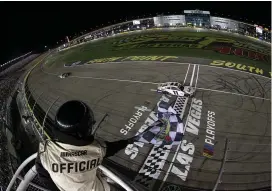  ?? (Meg Oliphant/getty) ?? Denny Hamlin, driver of the #11 Fedex Office Toyota, takes the checkered flag to win the Cup Series South Point 400 at Las Vegas Motor Speedway Sunday night.