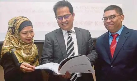  ?? PIC BY NUR ADIBAH AHMAD IZAM ?? Hektar Real Estate Investment Trust chief executive officer Datuk Hisham Othman (centre) with chief corporate officer Zarina Halim (left) and senior general manager of finance Khairul Azizan Ahmad at the company’s annual general meeting in Kuala Lumpur yesterday.