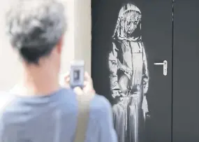  ??  ?? The recovered Banksy door, that was stolen at the Bataclan in Paris in 2019 and found in Italy last month.