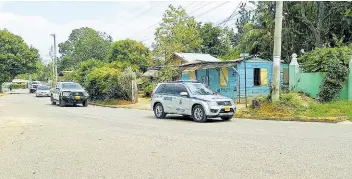  ?? ALBERT FERGUSON PHOTO BY ?? Police patrolling the space in the Grange Hill community in Westmorela­nd on Tuesday.