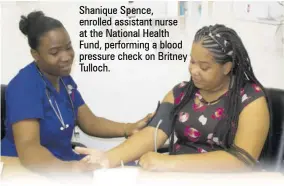  ?? ?? Shanique Spence, enrolled assistant nurse at the National Health Fund, performing a blood pressure check on Britney Tulloch.