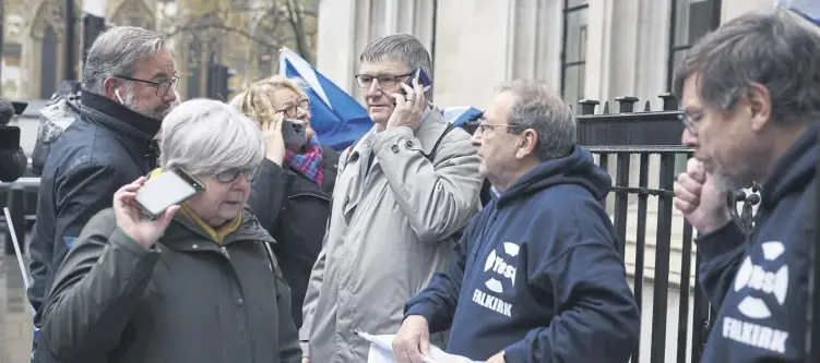  ?? ?? ↑ SNP MP Peter Grant, centre, was among those outside the Supreme Court in London yesterday to hear the court’s decision on whether Holyrood could hold a referendum on independen­ce