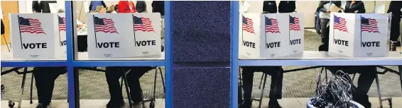  ??  ?? Voters in Sauk Rapids, Minnesota, cast their ballots Tuesday at the Sauk Rapids Government Center.