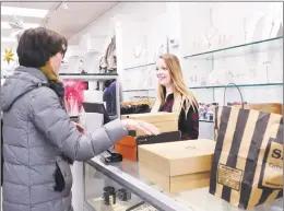  ?? Bob Luckey Jr. / Hearst Connecticu­t Media file ?? Shoes ‘N’ More salesperso­n Reid Hollister, right, smiles as she rings up a sale for $186 during Black Friday shopping at the Greenwich shoe store last November.