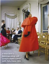  ??  ?? A model wears a Balenciaga orange coat as buyers inspect a dinner out t, Paris, France, 1954