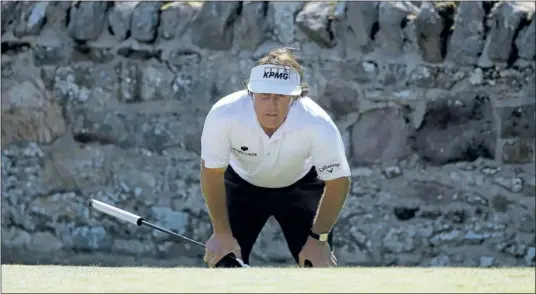  ?? BRIAN SNYDER
Reuters files ?? Phil Mickelson up a putt during the British Open this weekend at Muirfield in Scotland. Mickelson went 4-under over the tournament’s final six holes, a run that — given how difficult Muirfield was playing — ranks among one of the best stretches of golf...