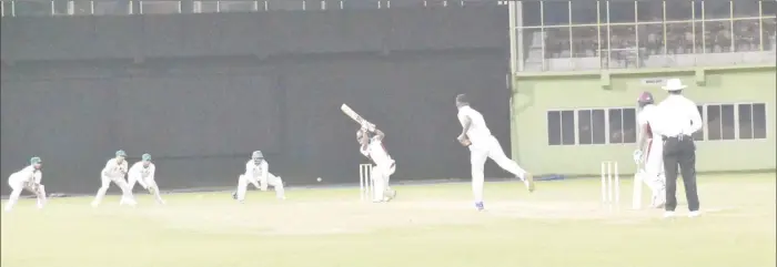  ??  ?? Night cricket at the stadium. Jaguar Sherfane Rutherford bowls to Hurricanes’ Akeem Saunders whilst wicketkeep­er Bramble and the Guyana slip cordon pay keen attention