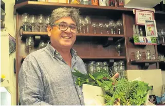  ??  ?? Eat where locals eat: Francesco Pinto, grandson of the original owners of the All’Arco snack bar in Venice, displays fresh herbs, which will be used in the day’s dishes.