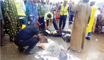  ??  ?? Rescue officials attend to accident victims at Ikorodu in Lagos yesterday, before they were taken to the hospital LASEMA