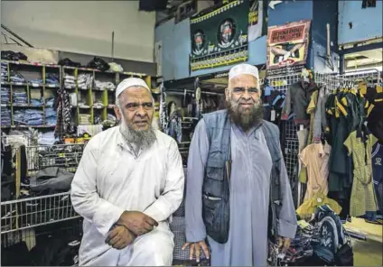  ??  ?? School uniforms: Hassan and Hussein Bulbulia in their shop on the ground floor of Master Mansions