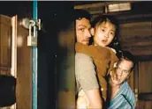  ?? Universal Pictures ?? FATHERS played by Ben Aldridge, left, and Jonathan Groff protect their daughter Wen (Kristen Cui).