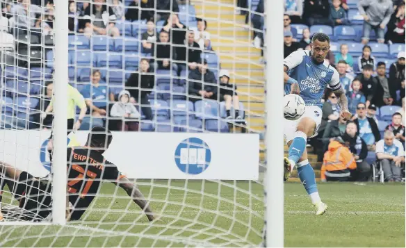  ?? ?? Jonson Clarke-Harris scores his 12th and final goal of the season for Posh against Blackpool. Photo: Joe Dent/theposh.com.